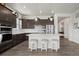 Spacious kitchen with island, stainless steel appliances, and dark cabinetry at 12664 Ulster St, Thornton, CO 80602