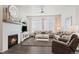 Spacious living room with fireplace, comfortable seating, and large windows at 12664 Ulster St, Thornton, CO 80602
