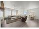 Open-concept living space with hardwood floors, fireplace, and dining area at 12664 Ulster St, Thornton, CO 80602