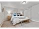 Comfortable bedroom with soft carpet, queen bed, bench, and sliding closet for a relaxing retreat at 1275 Winona Ct # B, Denver, CO 80204