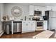 Modern kitchen with stainless steel appliances, white cabinets, and decorative details at 1275 Winona Ct # B, Denver, CO 80204