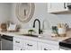 Close up on the modern kitchen featuring white cabinets and countertops with decorative accents at 1275 Winona Ct # B, Denver, CO 80204