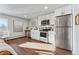 Updated kitchen with stainless steel appliances, modern cabinetry, and recessed lighting at 1275 Winona Ct # B, Denver, CO 80204