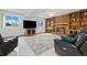 Finished basement with brick fireplace, built-in shelves, tile flooring and comfortable leather furniture at 11131 Seton Pl, Westminster, CO 80031