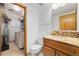 Bathroom with granite vanity, tile flooring, toilet, and laundry area, maximizing space and functionality at 11131 Seton Pl, Westminster, CO 80031