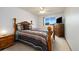 Comfortable bedroom with a wooden bed frame, soft pillows, and a picturesque view from the window at 11131 Seton Pl, Westminster, CO 80031