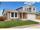 Charming two-story home featuring brick accents, gray siding, a well-manicured lawn, and a two-car garage at 11131 Seton Pl, Westminster, CO 80031