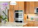 Gourmet kitchen features granite countertops, custom wooden cabinets and stainless steel appliances at 11131 Seton Pl, Westminster, CO 80031