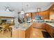Open kitchen with an expansive island, wooden cabinetry, stainless appliances, and hardwood floors at 11131 Seton Pl, Westminster, CO 80031