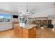 Kitchen with a center island, custom cabinetry and hardwood floors opens into the dining room at 11131 Seton Pl, Westminster, CO 80031