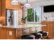 A kitchen island with seating, granite countertops, stainless steel appliances, and wooden cabinets offers a modern design at 11131 Seton Pl, Westminster, CO 80031