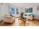 Bright living room with hardwood floors, large windows, and comfortable sofas at 11131 Seton Pl, Westminster, CO 80031