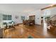 Open-concept living and dining area with hardwood floors, white walls, and ample natural light at 11131 Seton Pl, Westminster, CO 80031