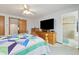 View of the main bedroom with a large television and an ensuite bathroom featuring a glass shower at 11131 Seton Pl, Westminster, CO 80031