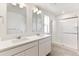 Bright bathroom featuring double sinks with shower and tub combo at 9886 Ceylon Ct, Commerce City, CO 80022