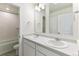 Bathroom featuring a double vanity with white cabinets and sinks at 9886 Ceylon Ct, Commerce City, CO 80022