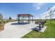 Outdoor picnic and grill area for residents' enjoyment, surrounded by grassy lawns and tree lined sidewalks at 9886 Ceylon Ct, Commerce City, CO 80022