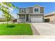 Beautiful two-story home with manicured lawn and a two-car garage at 9886 Ceylon Ct, Commerce City, CO 80022