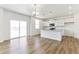 Modern kitchen featuring white cabinets and a granite island at 9886 Ceylon Ct, Commerce City, CO 80022