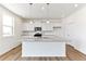 Bright kitchen boasts stainless appliances, granite countertops and an island with pendant lighting at 9886 Ceylon Ct, Commerce City, CO 80022