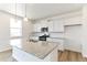 Bright kitchen features stainless appliances, granite countertops and a central island with a sink at 9886 Ceylon Ct, Commerce City, CO 80022
