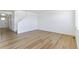 Spacious living area with wood floors, stairs, and bright, neutral walls at 9886 Ceylon Ct, Commerce City, CO 80022