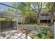 Tranquil outdoor space with a wooden fence, a covered deck, a patio, and blossoming foliage at 7190 S Poplar Ct, Centennial, CO 80112