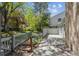 Charming backyard featuring a brick wall, patio, wooden fence, and lush garden area at 7190 S Poplar Ct, Centennial, CO 80112