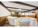 Open basement area featuring neutral carpet and tile flooring, built-in shelving, and comfortable white couches at 7190 S Poplar Ct, Centennial, CO 80112