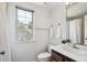 Bright bathroom showcasing a single sink vanity, a window and a shower at 7190 S Poplar Ct, Centennial, CO 80112