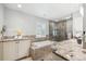 Bathroom featuring a large tub, a tiled glass enclosed shower and double sinks with granite countertop at 7190 S Poplar Ct, Centennial, CO 80112