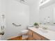 Powder room features wood flooring, grab bar and single sink vanity and decorative accents at 7190 S Poplar Ct, Centennial, CO 80112