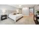 Neutral bedroom features a large headboard, neutral carpet, ceiling fan and side tables with lamps at 7190 S Poplar Ct, Centennial, CO 80112