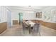 Elegant dining room with modern chandelier, view to living room and kitchen at 7190 S Poplar Ct, Centennial, CO 80112