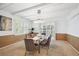 Elegant dining room with modern chandelier, large windows, and stylish chairs at 7190 S Poplar Ct, Centennial, CO 80112