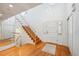 Bright entryway with hardwood floors, staircase, and modern lighting fixtures at 7190 S Poplar Ct, Centennial, CO 80112