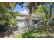 Back exterior view of a well-maintained home with a charming deck overlooking a landscaped yard at 7190 S Poplar Ct, Centennial, CO 80112