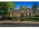 Charming brick home with dormer windows, mature trees, and inviting landscaping at 7190 S Poplar Ct, Centennial, CO 80112