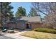 Charming building with brick exterior, mature trees, and manicured lawn offering a welcoming entrance at 7190 S Poplar Ct, Centennial, CO 80112