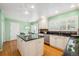 Kitchen showcases center island, white cabinets, stainless steel appliances, and hardwood floors at 7190 S Poplar Ct, Centennial, CO 80112