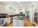 Bright kitchen features white cabinets, black countertops and hardwood floors, plus stainless steel appliances at 7190 S Poplar Ct, Centennial, CO 80112