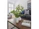 Close up of living room coffee table styled with plants and decorative books at 7190 S Poplar Ct, Centennial, CO 80112