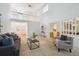 Bright and airy living room with view of dining room, neutral decor, and tall ceilings at 7190 S Poplar Ct, Centennial, CO 80112