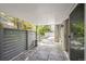 Comfortable covered patio area with stone tile flooring and a view of the backyard with trees and plants at 7190 S Poplar Ct, Centennial, CO 80112