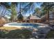 Exterior view of a community pool under a covered structure, and surrounded by mature trees and landscaping at 7190 S Poplar Ct, Centennial, CO 80112