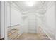 Organized walk-in closet with multiple shelves and storage baskets for optimal storage at 7190 S Poplar Ct, Centennial, CO 80112