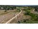 An aerial view showcases winding trails through lush fields, inviting outdoor exploration amidst natural beauty and tranquility at 12665 Grove Ct, Broomfield, CO 80020