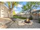 Backyard with fire pit area, artificial grass, and a wooden fence for privacy at 12665 Grove Ct, Broomfield, CO 80020