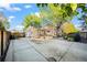 Expansive backyard with a large concrete patio, detached garage, and mature trees at 12665 Grove Ct, Broomfield, CO 80020