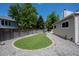 Landscaped backyard featuring a synthetic grass lawn and stone ground cover at 12665 Grove Ct, Broomfield, CO 80020